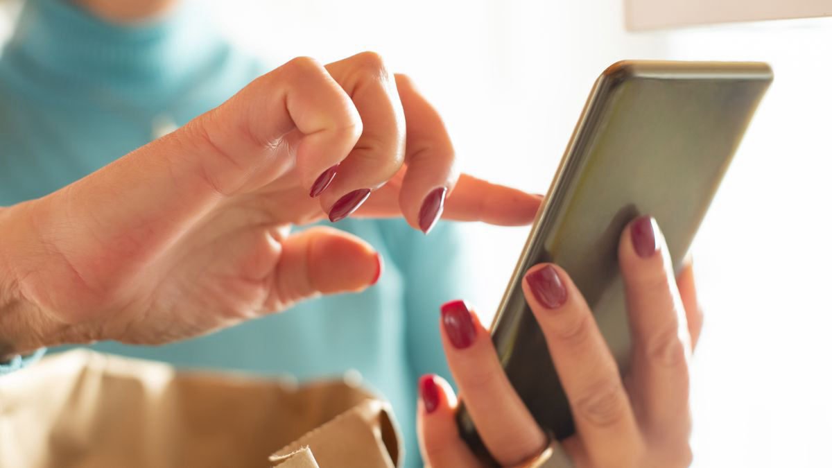 Hands tapping through an app on a smartphone screen