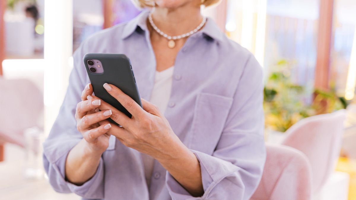 Woman using her smartphone in a bright, modern room