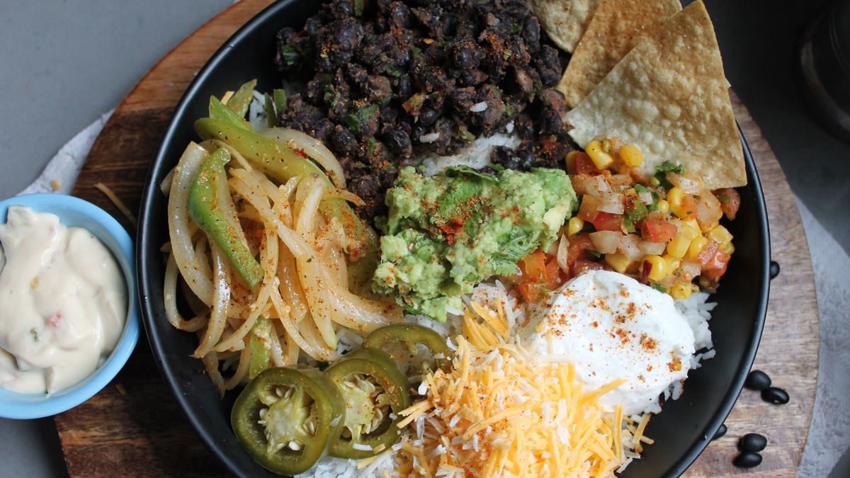 Burrito bowl with guacamole, black beans and shredded cheese