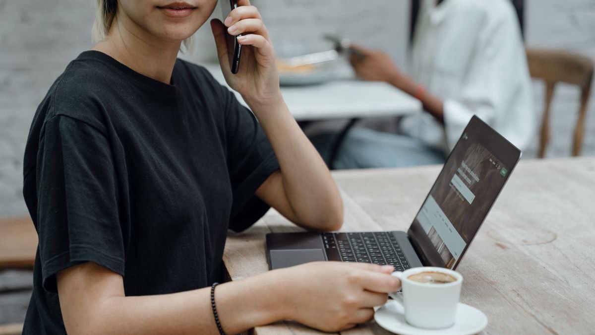 A woman in a coffee shop using her phone