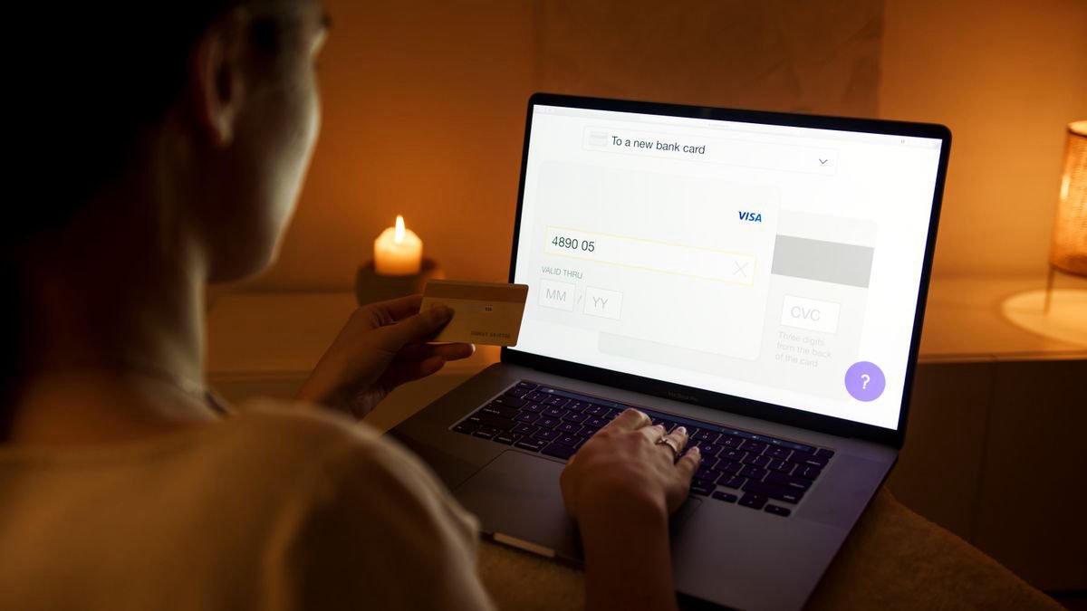 Woman making a secure online payment with a laptop and card