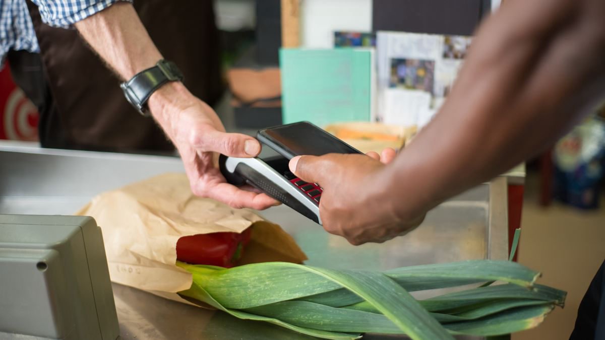 Customer making a contactless payment with a smartphone at a store