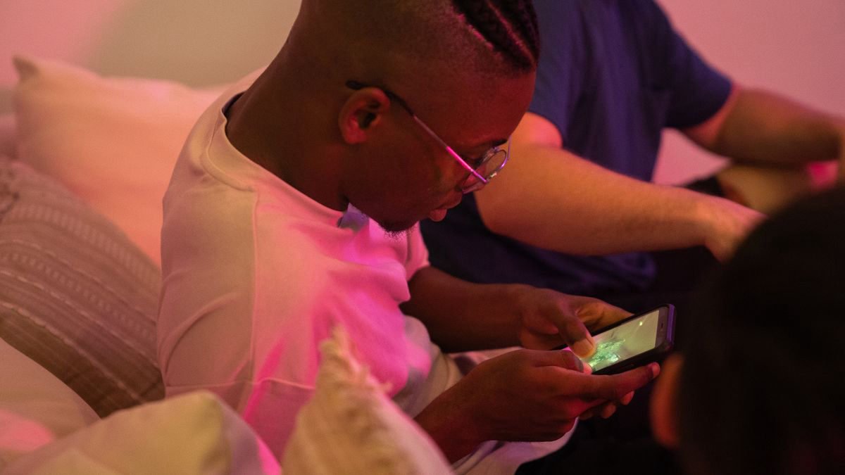 Group of friends playing games on their phones together
