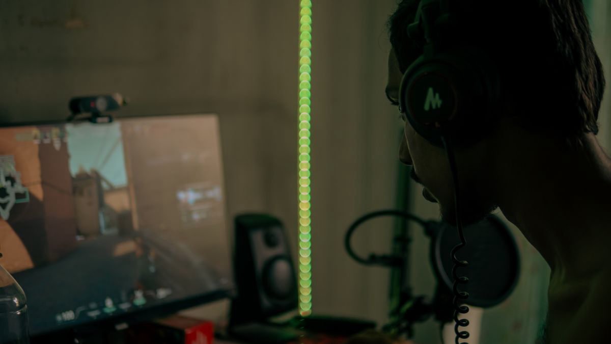 Gamer wearing a headset focused on a video game