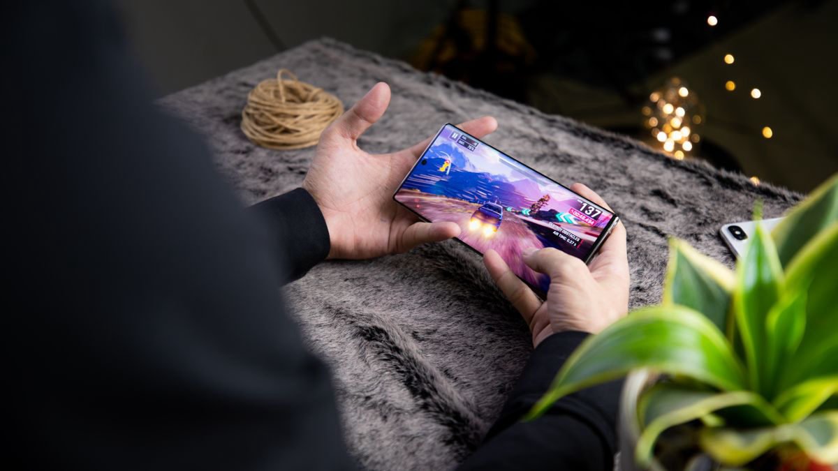 Person playing a game on a modern smartphone, seen from above