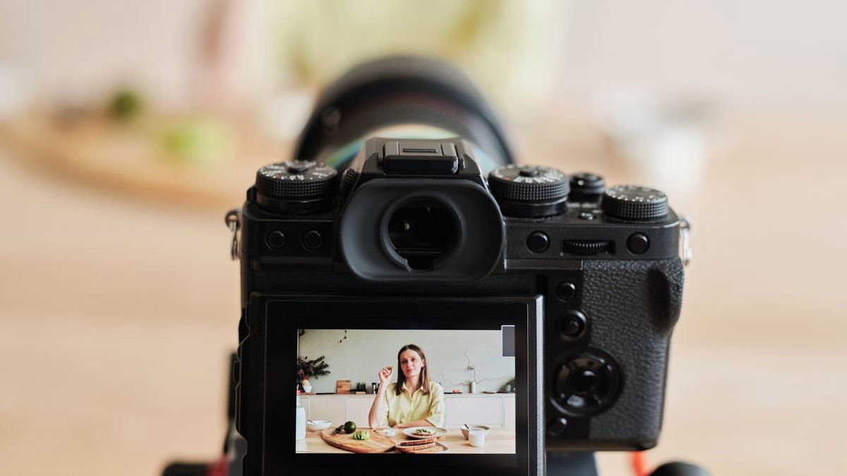 Creator recording a video at home with a camera