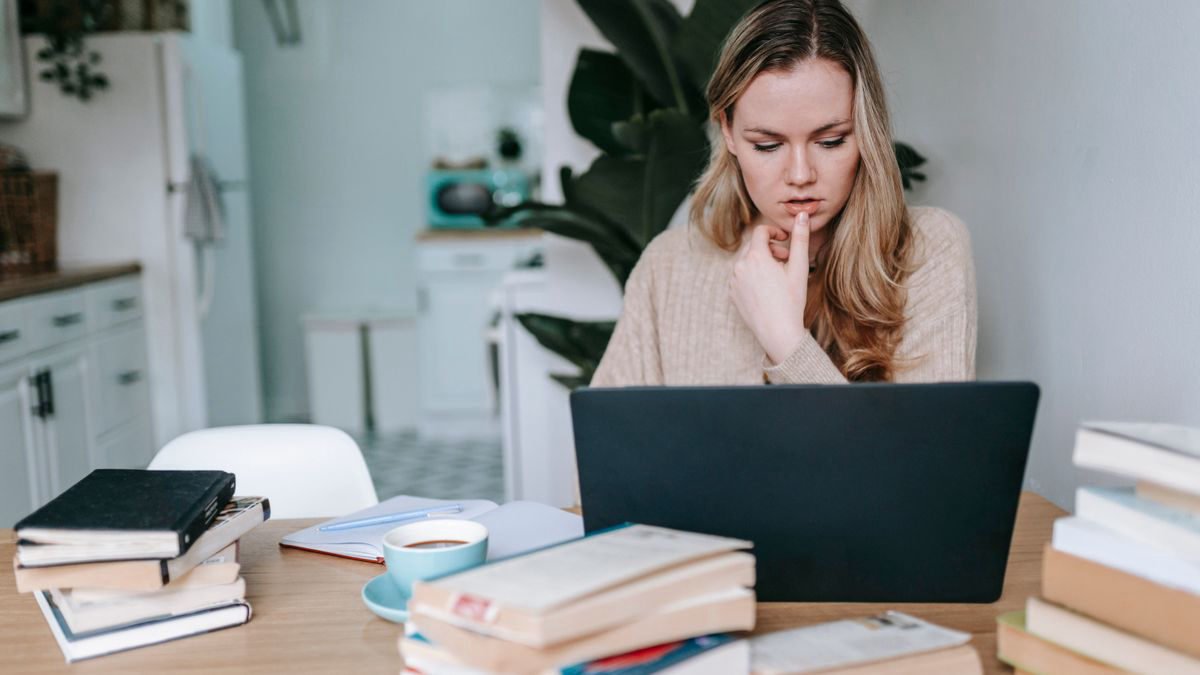 Woman studying online on a laptop at a table