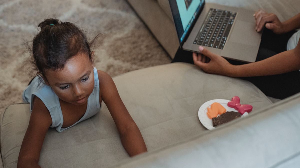 Mother using a laptop for remote work at home