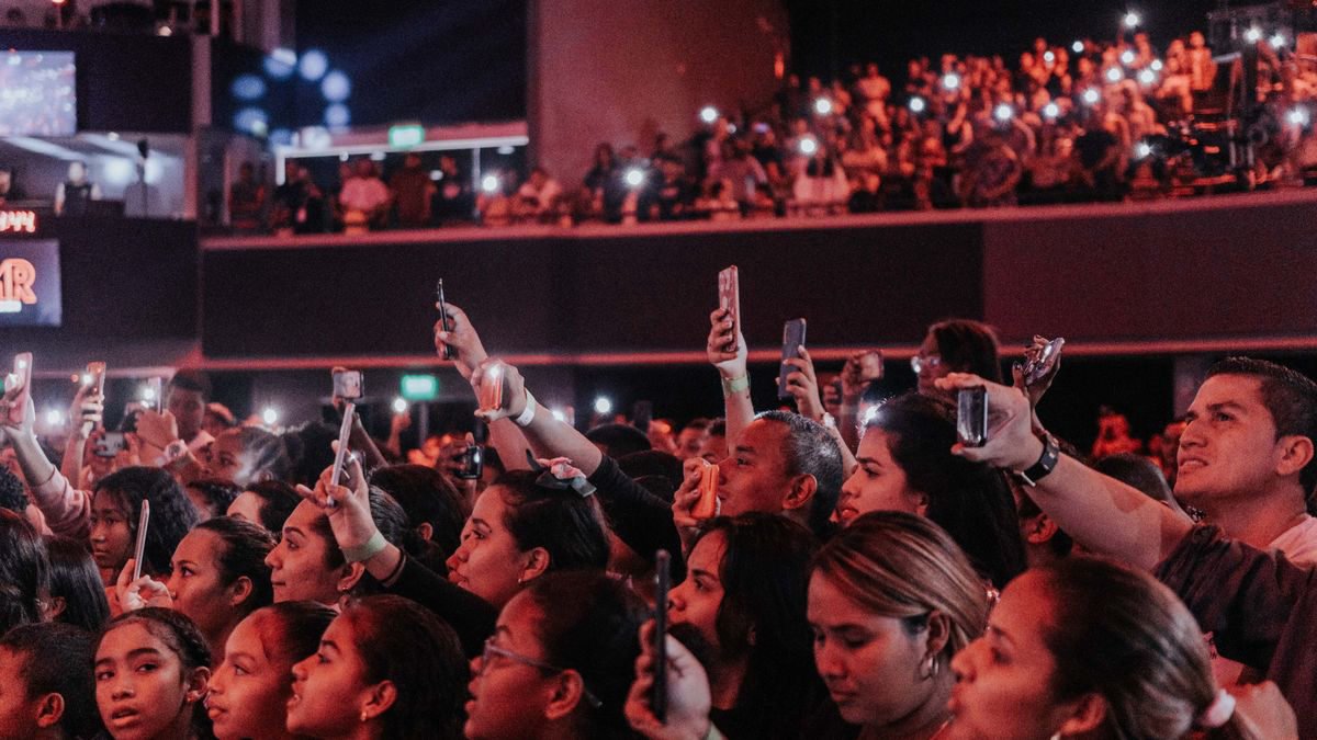 Audience enjoying a live concert and filming on their phones